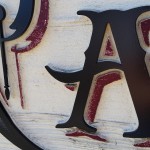 Close up of painted sandblasted cedar.