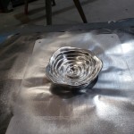 Chrome spray painted liquid metal bullet hole