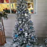 Six foot snow flocked Christmas tree decorated